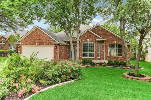 Aerial view of manicured Texas residential lawn with mowing stripes